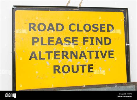 temporary yellow road closed  find alternative route sign stock