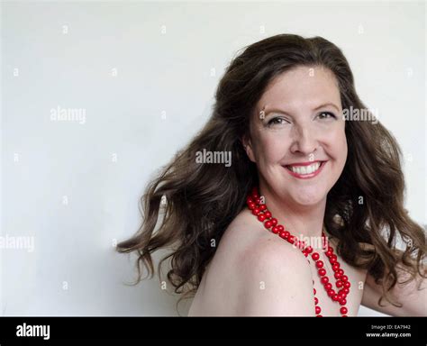 Studio Portrait Of Smiling Brunette Mid Adult Woman Stock Photo Alamy