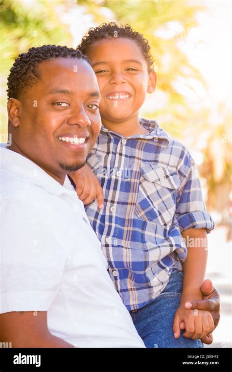 Mixed Race Son And African American Father Playing Outdoors Together