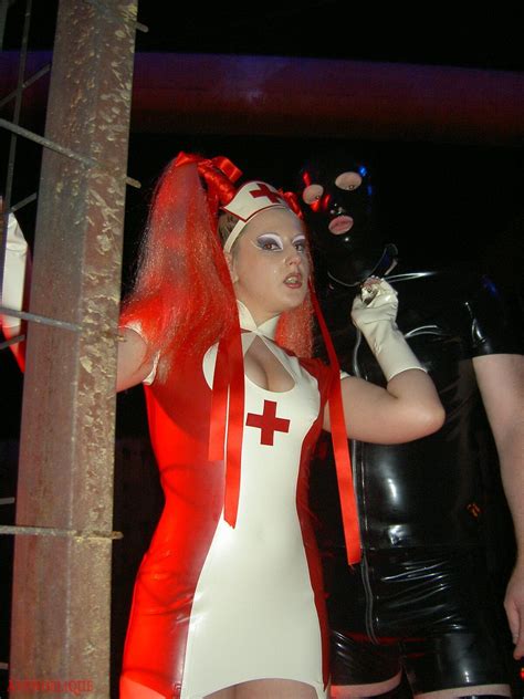 Hot Mistress Wearing A Red Latex Nurse Costume Photos