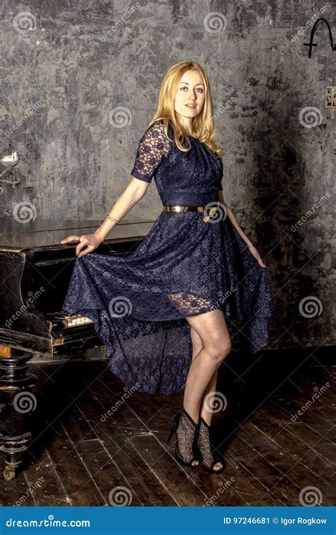 Beautiful Blonde Woman In An Elegant Dress At The Piano In A Dark Room Stock Image Image Of