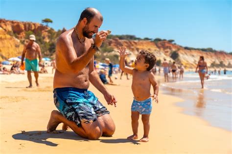 Premium Photo Father Playing In The Sand Praia Do Barranco Das