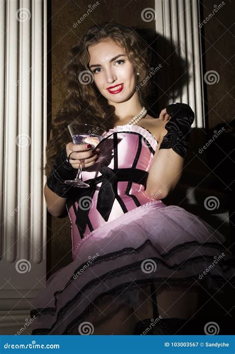 Cabaret Woman In Corset Posing With A Glass Burlesque Lingerie In Fashion Interior Stock Image