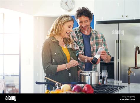 Getting In On The Cooking Action A Happy Mature Couple Preparing A Meal Together At Home Stock