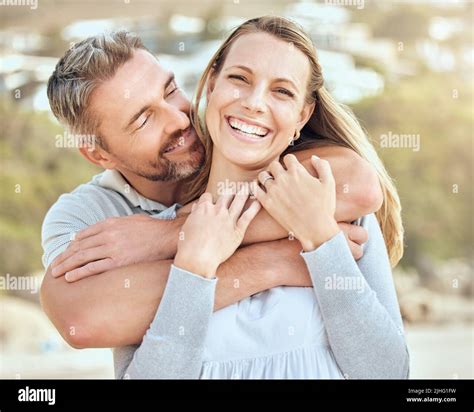 Happy And Loving Mature Caucasian Couple Enjoying A Romantic Date At The Beach Together On A