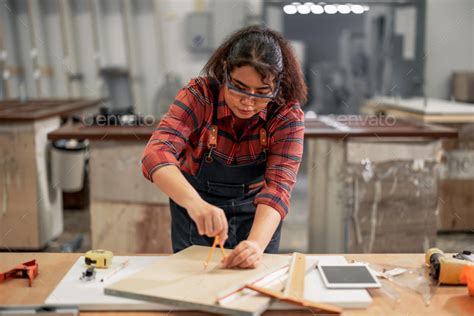 Carpenter crafts with skill, precision, using various tools - scribe, square, ruler, caliper ...