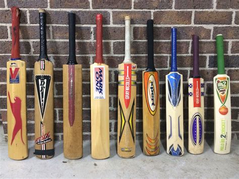 Cricket Bats Collection Displayed Against Brick Wall