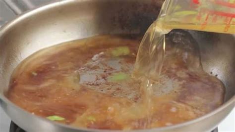 Deglazing caramelised juices with stock - Stock Video Footage - Dissolve