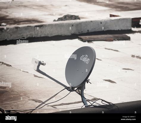 A Dish Network Satellite Dish On The Rooftop Of A Building In The New