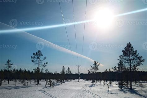 Light effects and vapor trail with power line in Swedish winter