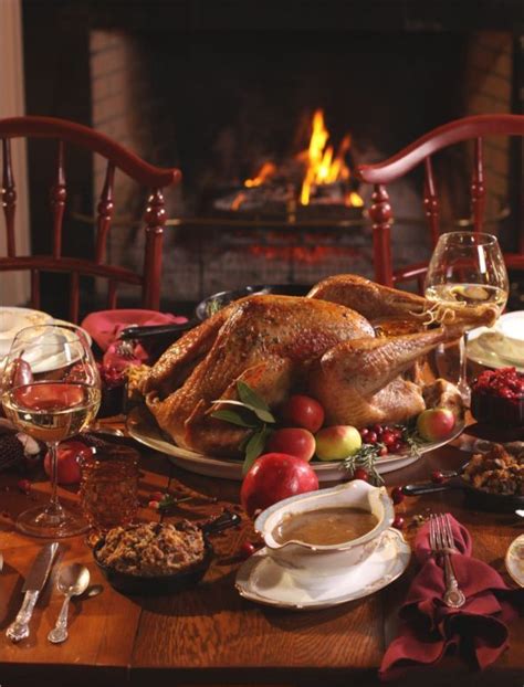 A Turkey Sitting On Top Of A Wooden Table Next To A Fire Place Filled