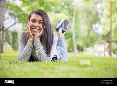 Pretty Brunette Smiling At Camera In Park Stock Photo Alamy