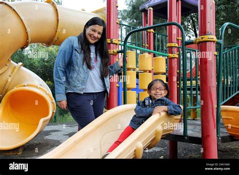 Divorced Single Mom And Brunette Latina Year Old Daughter Play In The Park Games In Poverty