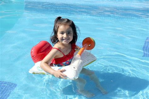 Year Old Latina Girl Swims In The Pool With An Inflatable Float Toy Very Happy Enjoying Her