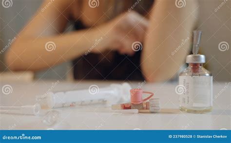 Woman Holds Cotton Wool On Her Hand After Injection Used Syringe And