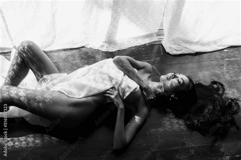 Nude Asian Woman Lying On Wooden Floor By Window Stock Photo Adobe Stock
