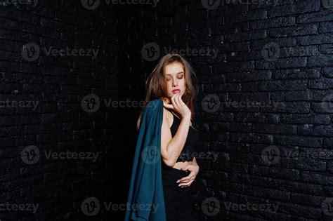 Handsome Brunette Girl Wear On Black Posing At Studio Against Dark Brick Wall Studio Model