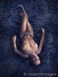 Photo Of Beautiful Nude Woman Lying In Dark Water Relaxed With Closed Eyes View From Above