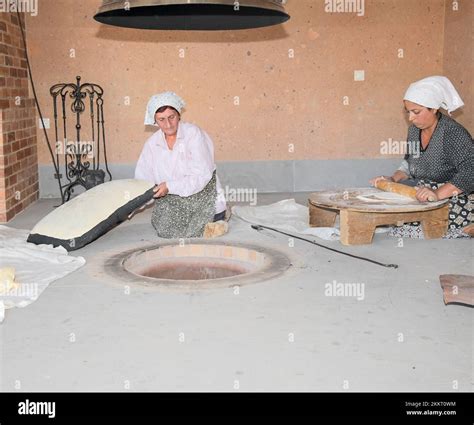 Women Baking Typical Armenian Lavash Bread In The Tonir Earth Oven