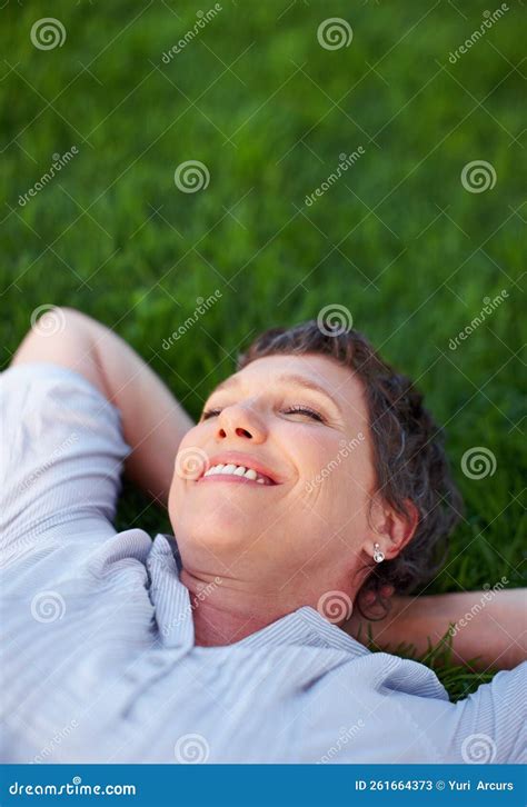 Relaxing Moments Relaxed Mature Woman Smiling While Lying On Grass Stock Image Image Of