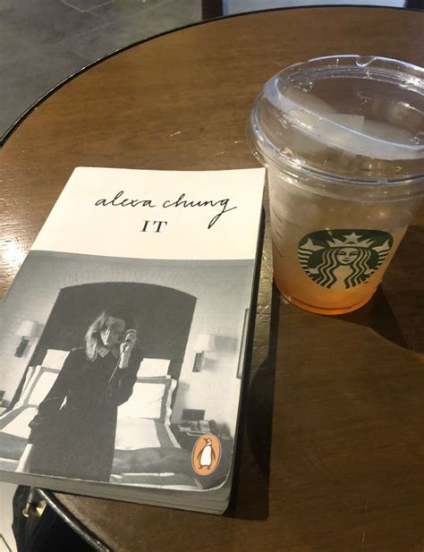 A Starbucks Drink And Book Sitting On A Table