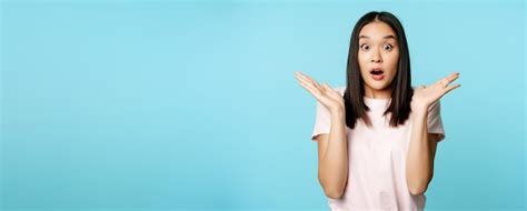 Free Photo Portrait Of Surprised Brunette Asian Woman Shrugging Gasping And Looking Shocked
