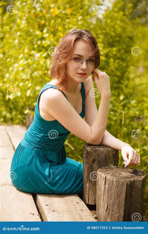 Young Girl In Blue Dress Sitting On Wooden Pier Stock Image Image Of