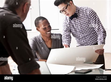 Three Business People In Meeting Stock Photo Alamy