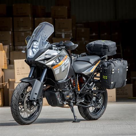 a motorcycle parked next to boxes in a warehouse with it's luggage on ...