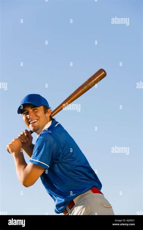 Baseball player swinging baseball bat, (low angle view Stock Photo - Alamy