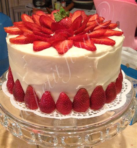 A Strawberry Blossom Cake Decorated With Fresh Strawberries And Cream