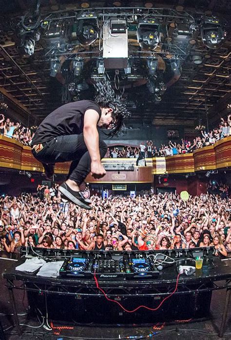 A Man Flying Through The Air While Riding A Skateboard On Top Of A Stage