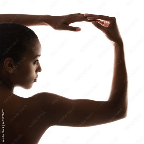 Silhouette Of Femininity Graceful Nude Woman Posing Against A White Background Stock Photo