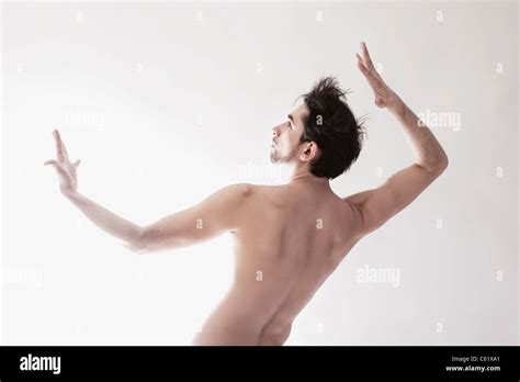 Young beautiful икгтуе naked man dancing on white background Stock Photo Alamy