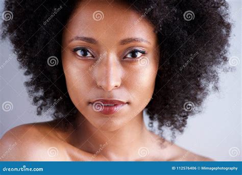 Close Up Beautiful African Woman With Curly Hair And Naked Shoulders