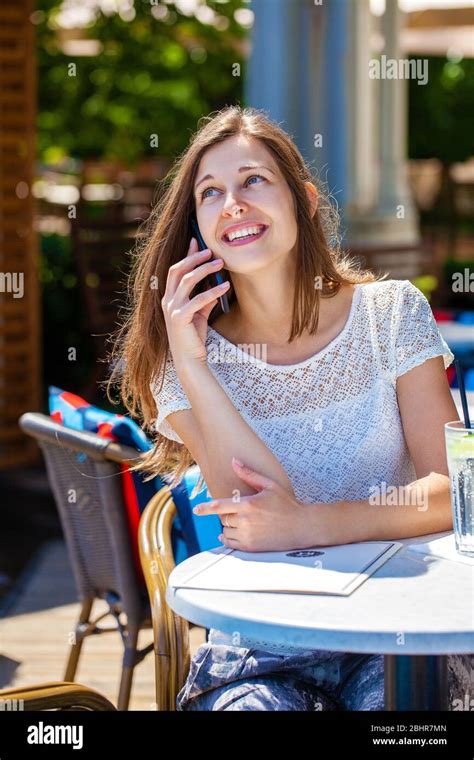 Happy Brunette Woman Calling By Phone In Open Air Cafe Stock Photo Alamy