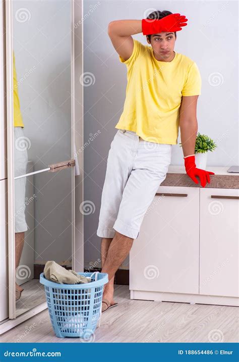 Young Handsome Man Cleaning In The Bedroom Stock Photo Image Of