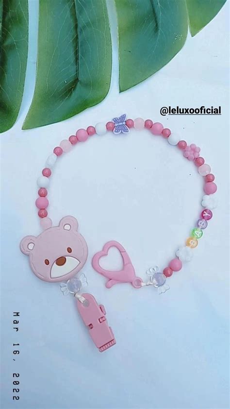 A Pink Bracelet With A Bear And Heart Charm