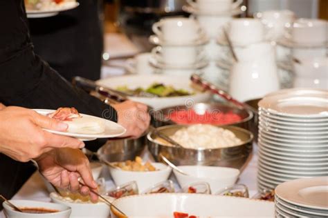 People Are Picking Food From A Buffet In A Restaurant During A Festive