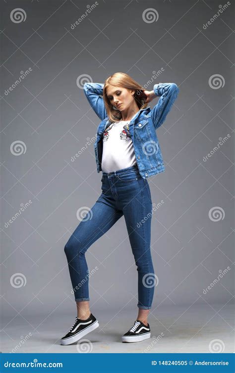 Beautiful Blonde Woman Dressed In A Denim Jacket And Blue Jeans Stock Image Image Of Beautiful