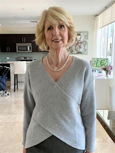 An Older Woman Standing In A Living Room