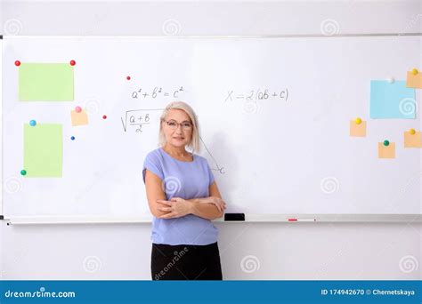 Mature Teacher Near Whiteboard In Classroom Stock Photo Image Of Learn Female 174942670