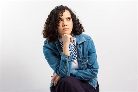 Premium Photo Curvy Latina Model With Curly Style Hair Sitting With Pensive Pose Looking At
