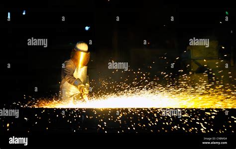 worker using torch cutter to cut through metal Stock Photo - Alamy