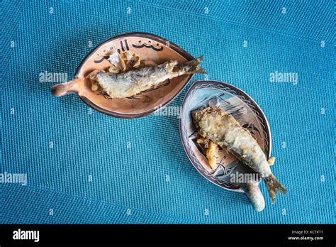 Fried Sardines On Plates Mediterranean Fish On Blue Background Stock