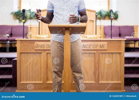 Person Reading The Bible On A Wooden Stand In The Church Stock Image