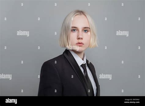 Pretty Woman With Short Straight Blonde Hair Wearing Black Male Style