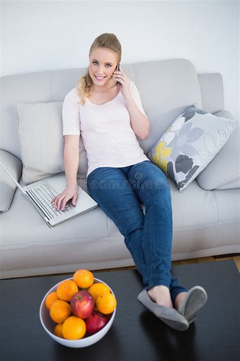 Casual Smiling Blonde Phoning And Using Laptop Stock Photo Image Of Attractive Couch