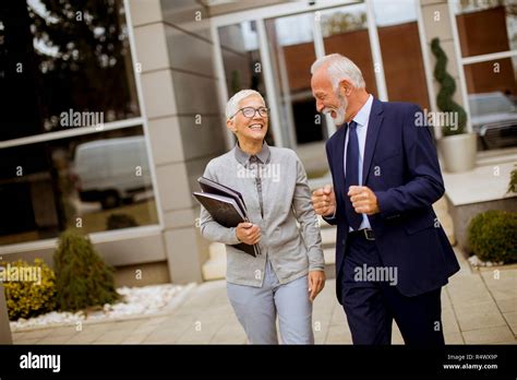 Senior Businesspeople Standing And Talking Outdoor Office Building