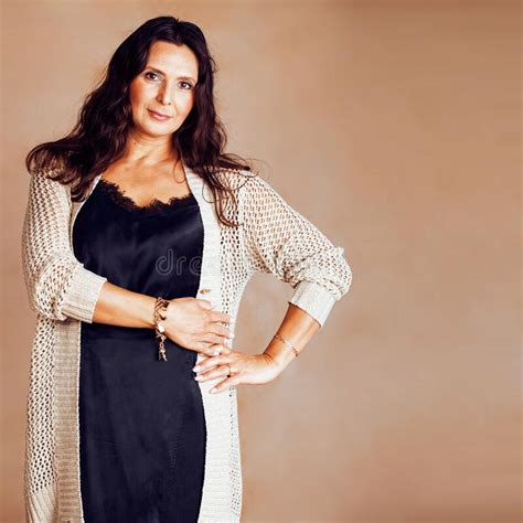 Pretty Brunette Confident Mature Woman Posing Cheerful On Warm Brown